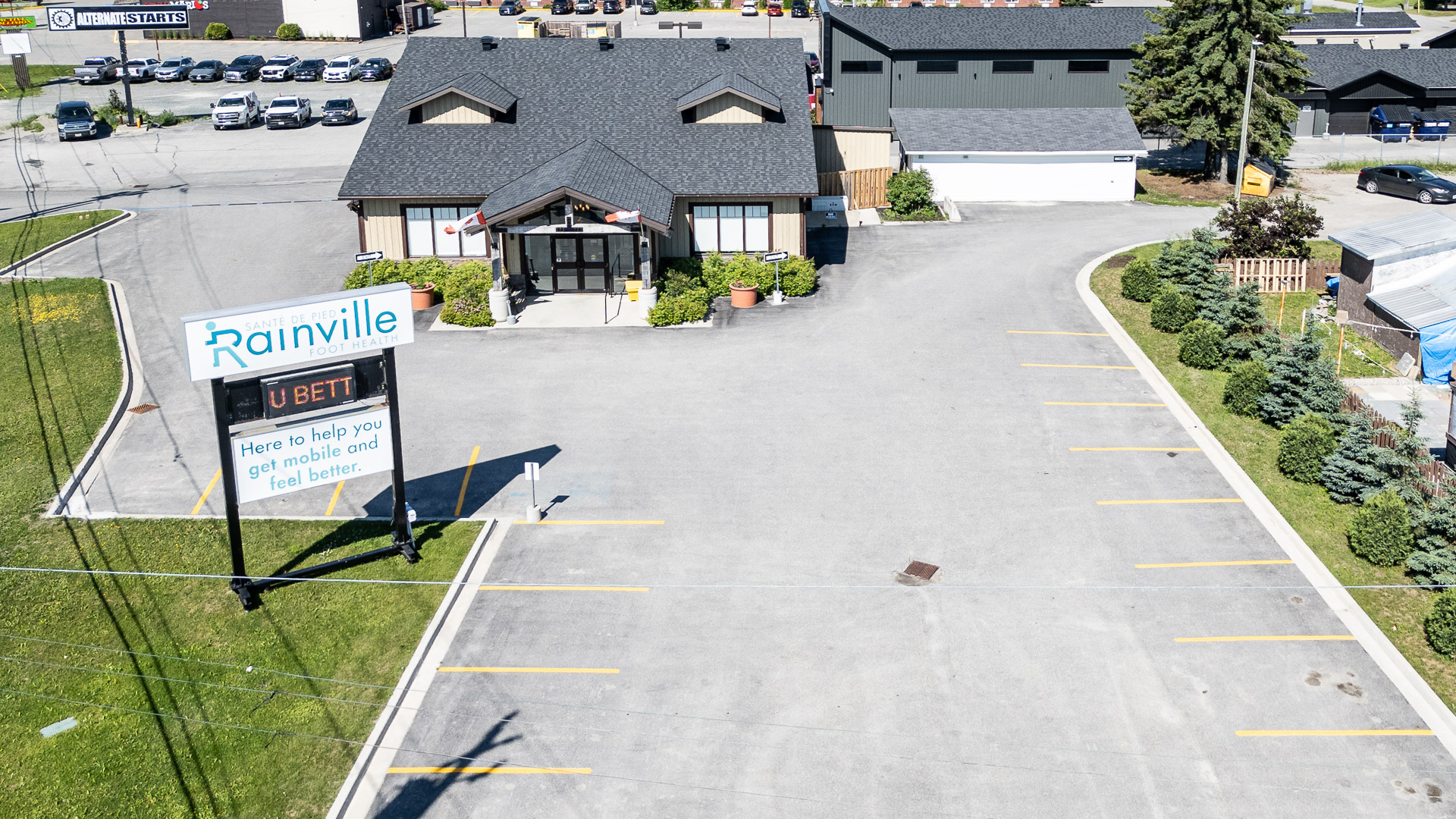 Aerial view of the front entrance and roadside pylon sign at 1086 Riverside Drive